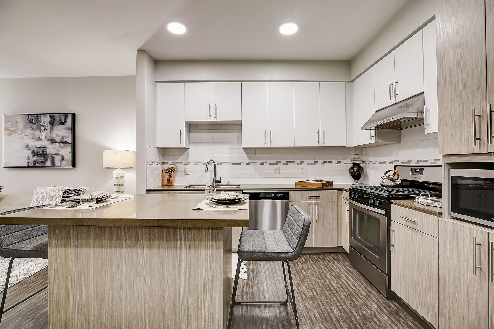 Modern kitchen with a central island, stove, and sink.